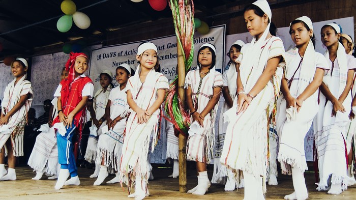 Karen girls perform a cultural dance in the refugee camp during a campaign to stop violence against women.